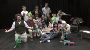 Photo by Abigail Vela's phone. from left: Ian Price (Herald/Harold) Thomas Kelleher (Lord Pain/QB), Cameron Mellin (Shane), Briandaniel Oglesby (Playwright), Callie Raynor (Marie), Laura Rogers (Marla the like Psychic), Alani Chock with a fishbowl (Narrator/Young Dino), Ben Hardin (Director), Audrey Long (Queeny and Queen), James McMasters (Lug), Abigail Vela (Cynthia/Guard), Meredyth Pederson (Stage Manager) holding Brock the sword, Luke Gracia (Otis)