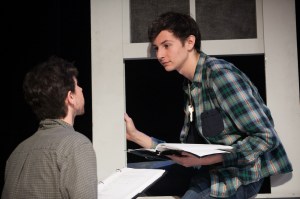 The boy (Brad Rizzo) leaves through the window as Dirt (Kevin Hippler) looks on. Photo by Lawrence Peart, courtesy of the University of Texas at Austin